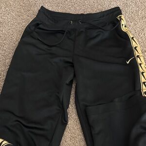 Nike Black Joggers with Gold Accents